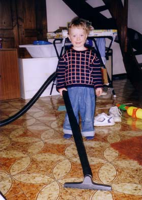 Michail helps mom in cleaning up the house